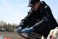 A Little 500 mechanic works on fixing a tire.